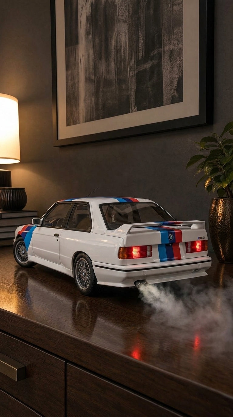 White BMW E30 M3 model with blue, violet and red M stripes and rear wing, smoke from the twin exhaust