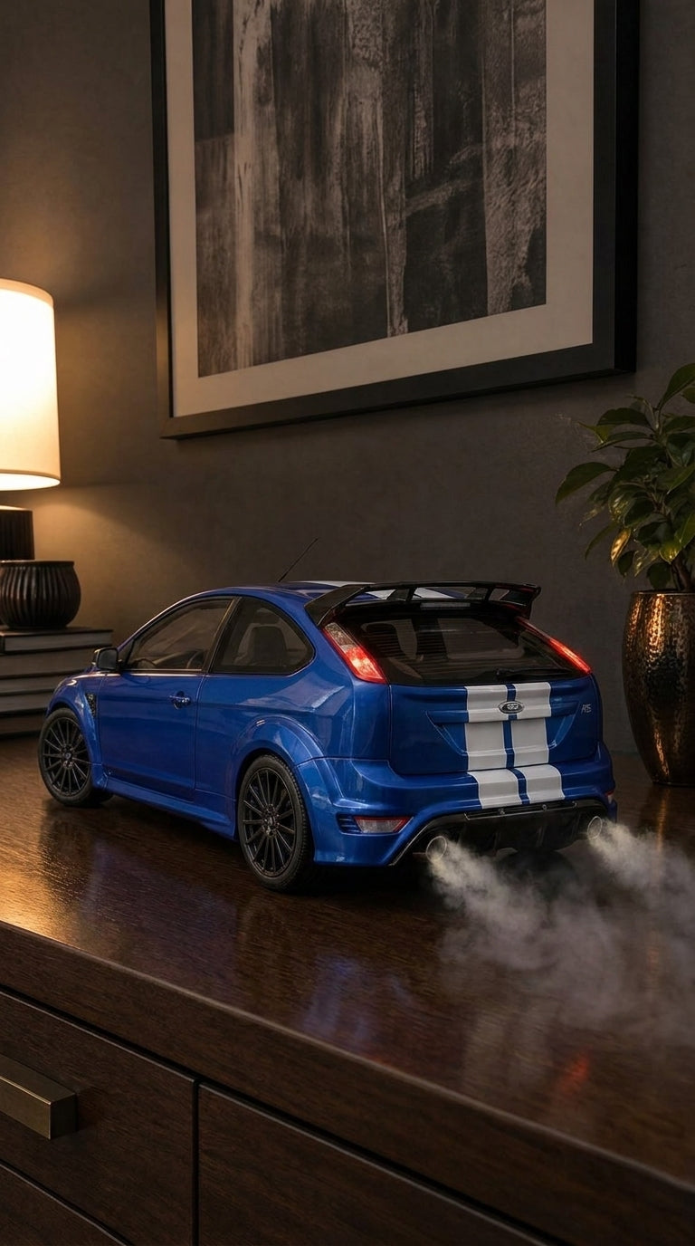 Blue Ford Focus RS Mk2 model with white stripes, flared arches and split rear wing, smoke from twin exhausts