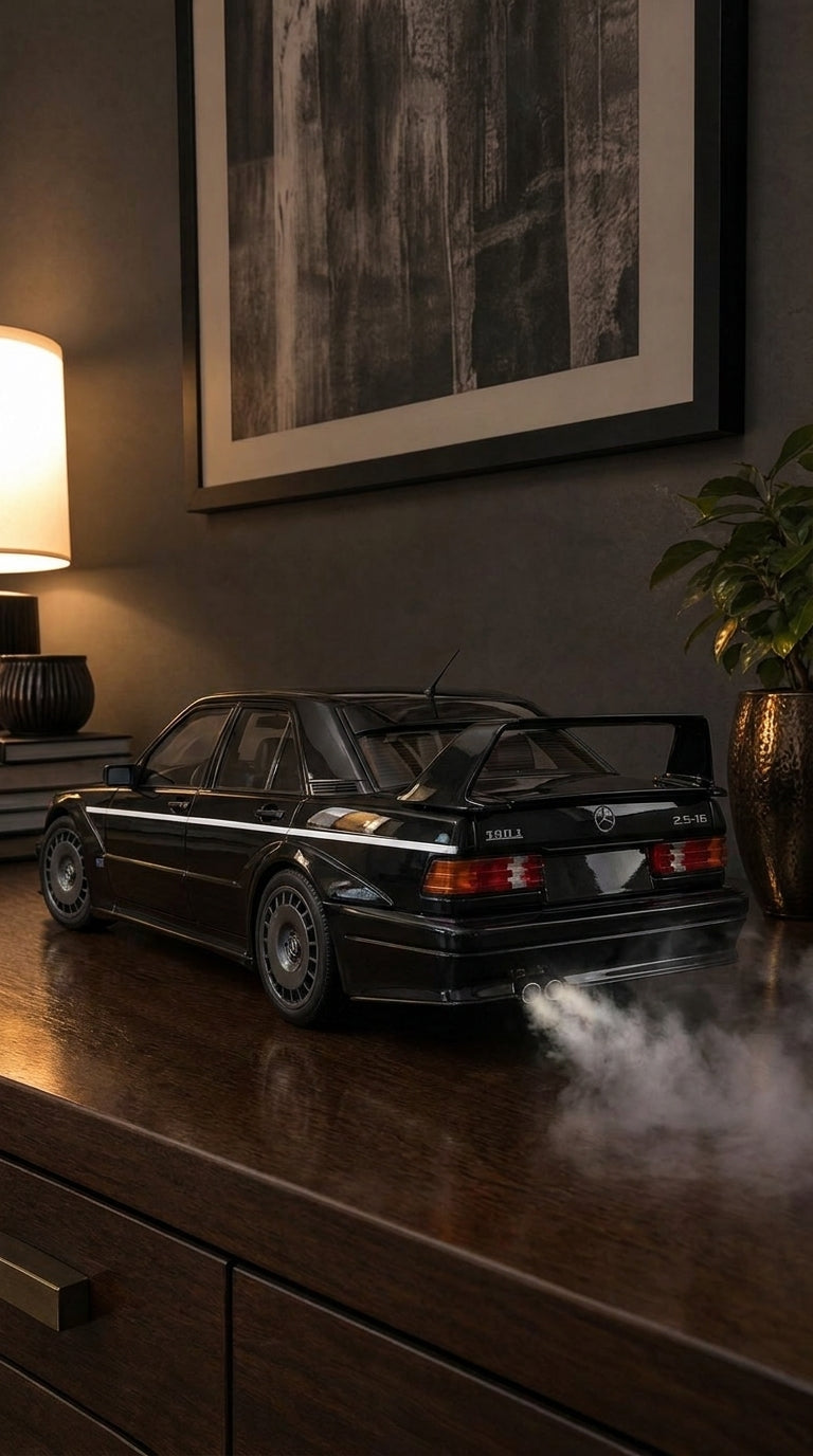 Black Mercedes-Benz 190E 2.5-16 Evo II model with tall rear wing and silver pinstripe, smoke from the twin exhaust
