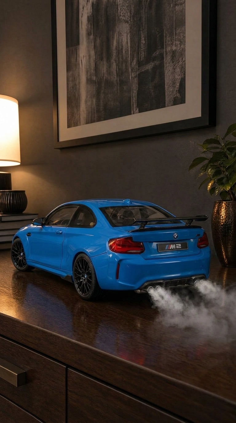 Blue BMW M2 coupe model with carbon-look rear wing and black wheels, smoke from the quad exhaust
