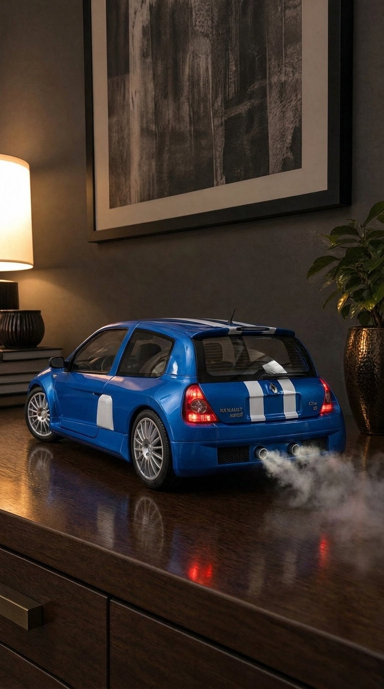 Blue Renault Clio V6 model with white stripes, wide arches and side intakes, smoke from the twin exhausts