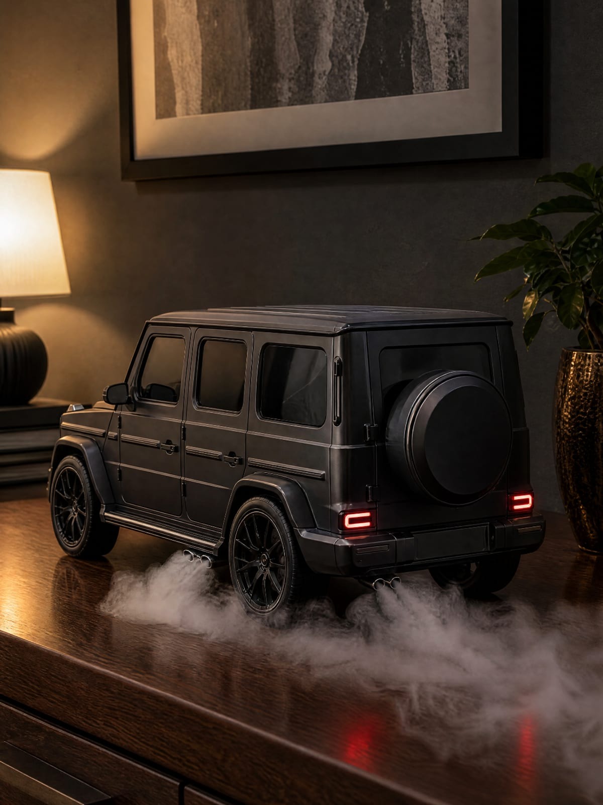 Matt black G-Wagon model with spare wheel on the rear door, smoke from side-exit exhausts on a wooden dresser